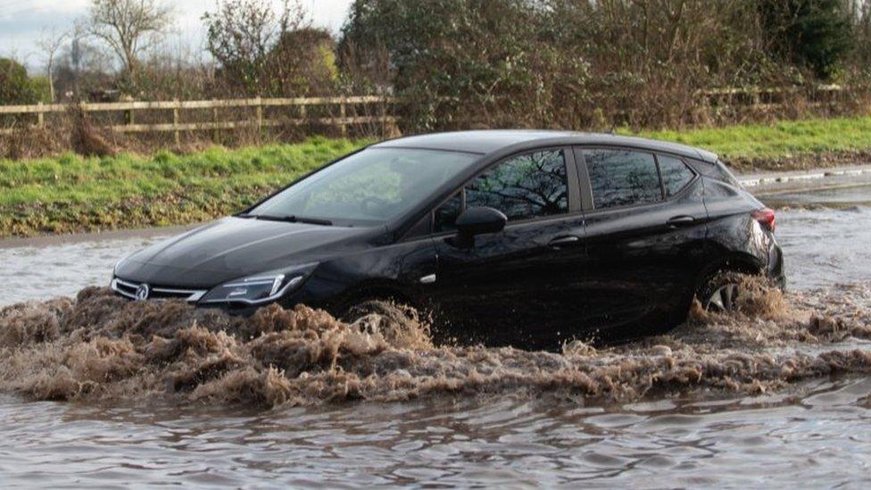 Car driving through floodwater in Hathern