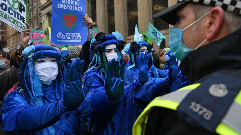 Police and protestors at COP26