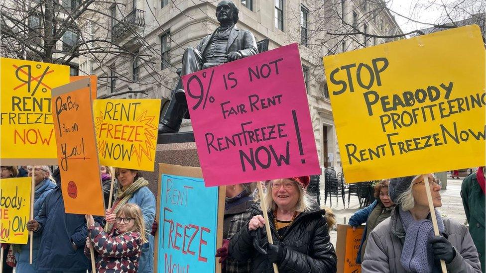 Protesters holding placards