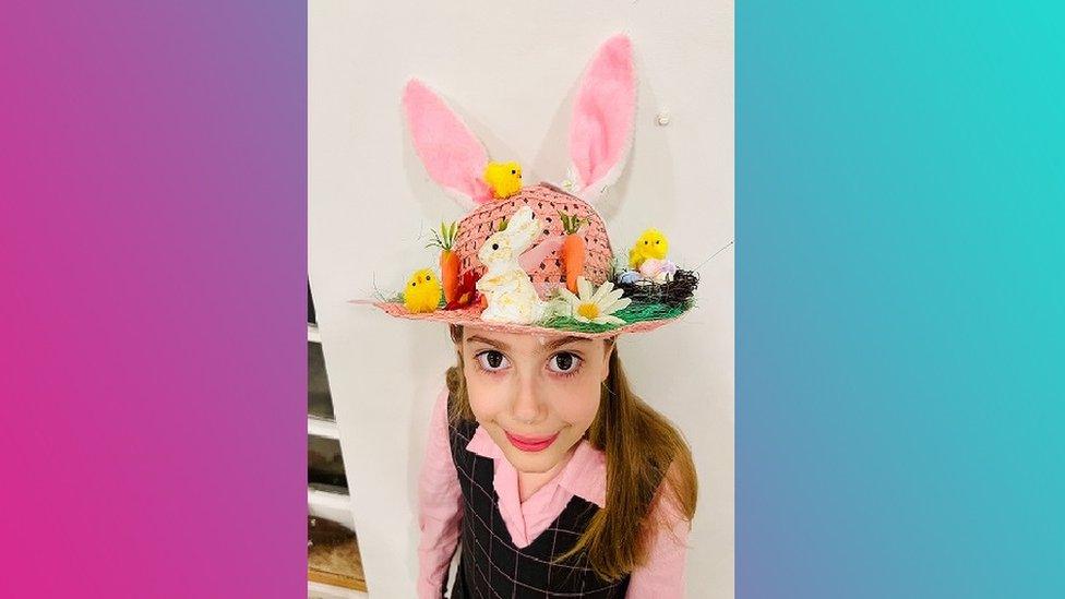 Girl in bonnet with rabbit ears.