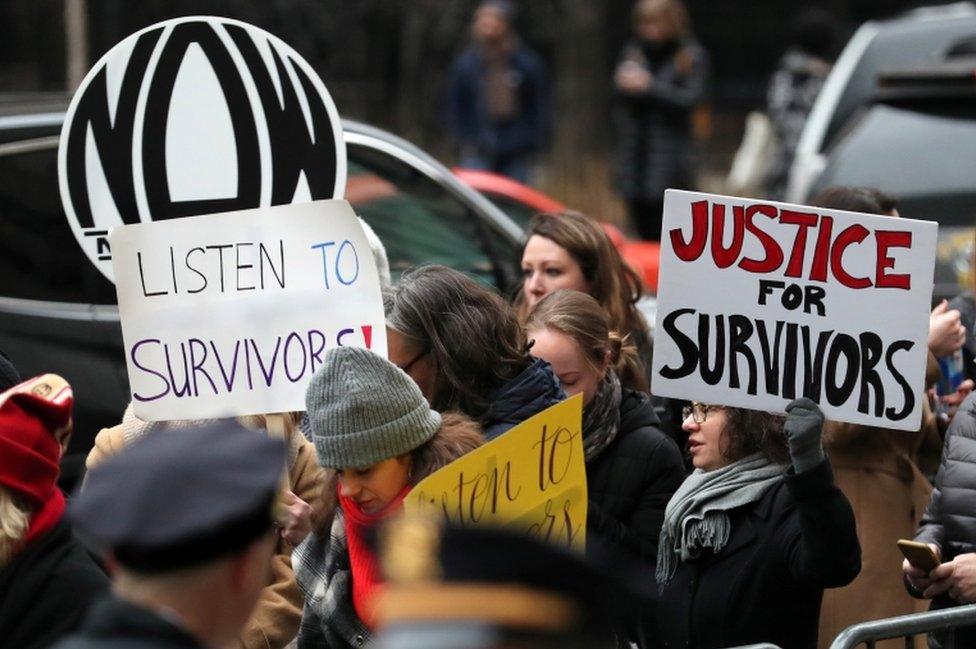 Protesters held signs outside the court on Monday