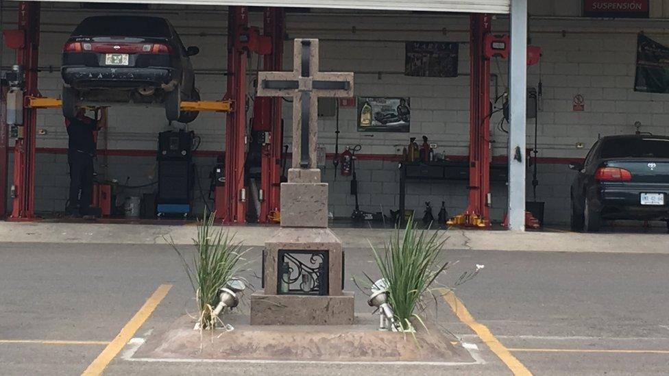 A cross marks the spot where Joaquin Guzman's son was shot dead