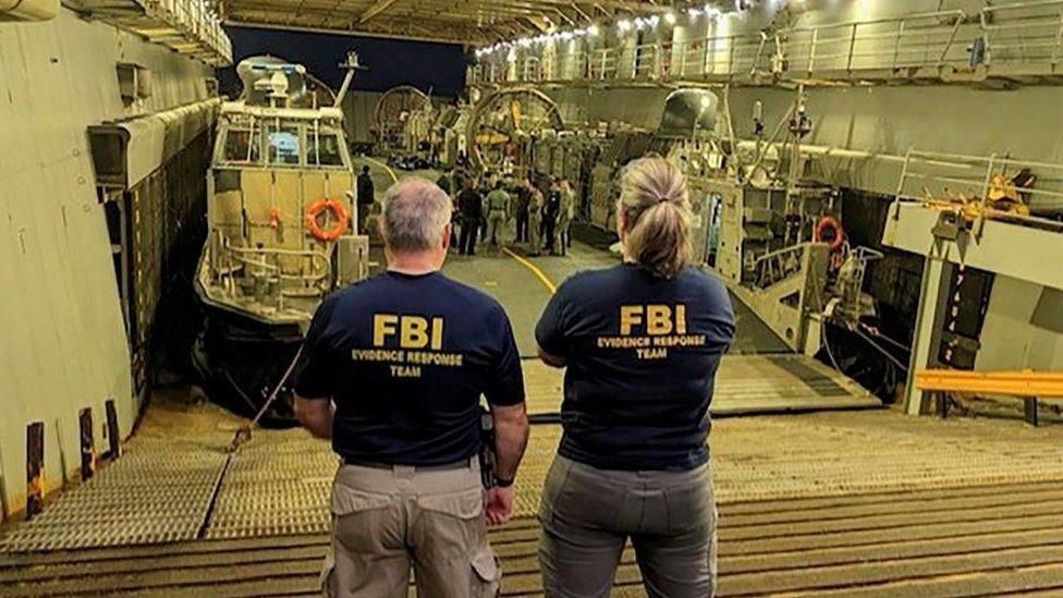 FBI agents looking at wreckage