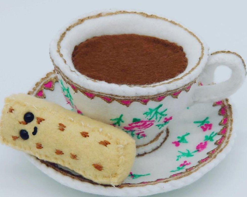 A felt cup and saucer with a side of shortbread