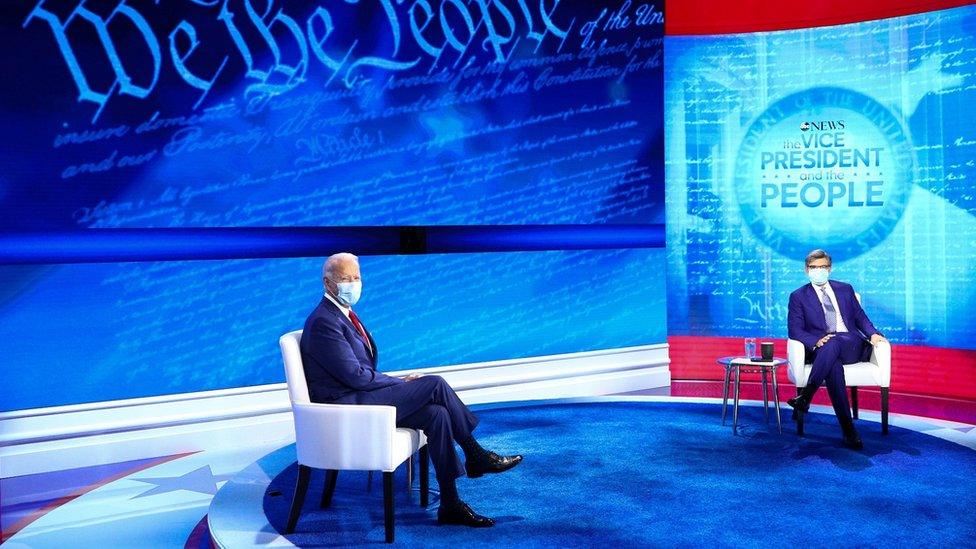 US Democratic presidential candidate Joe Biden sits on stage beside host George Stephanopoulos ahead of a town hall event on ABC