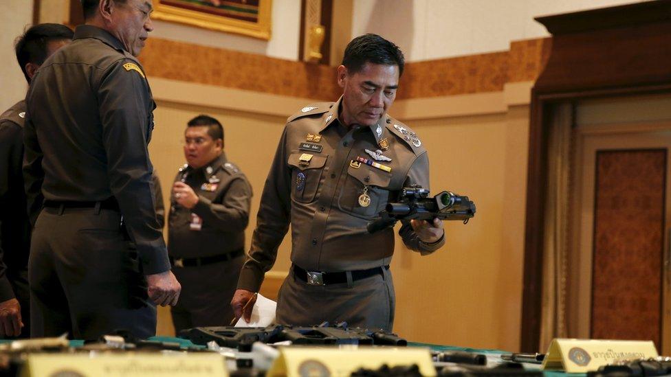 National police chief Chakthip Chaijinda inspecting alleged evidence at Bangkok news conference