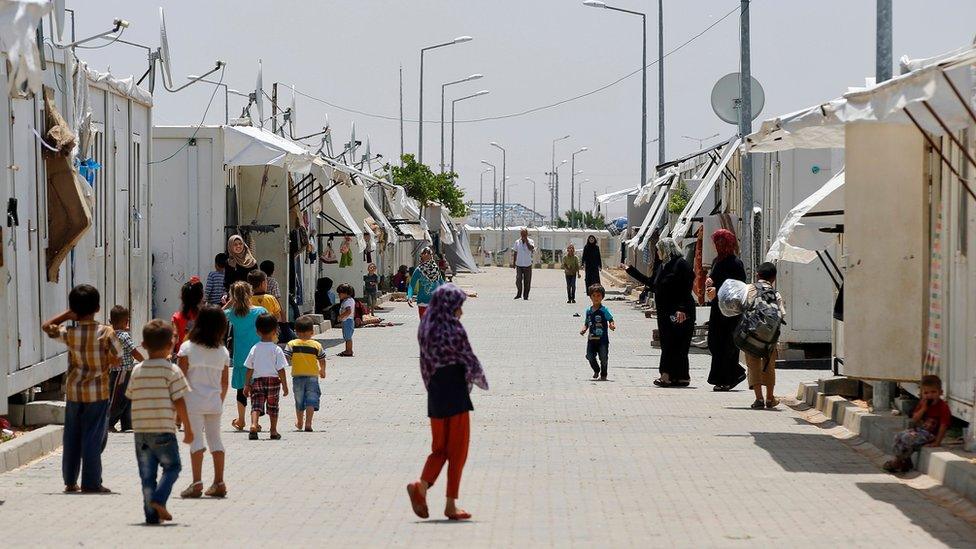 Syrian refugees go about their lives at the Oncupinar camp for Syrian refugees next to the border crossing with Syria, near the town of Kilis in southeastern Turkey, Monday, June 20, 2016.