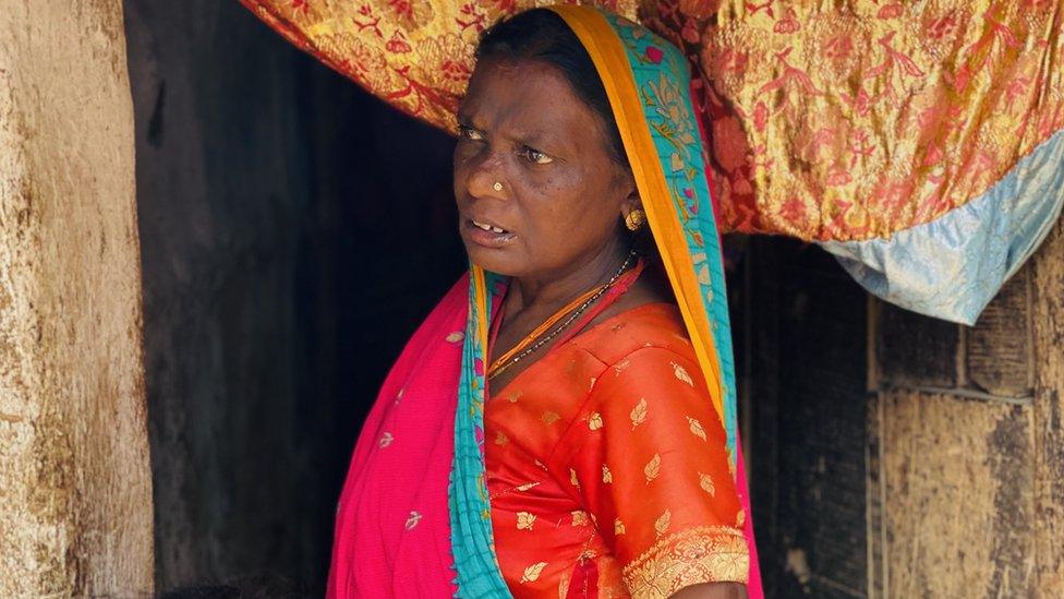 Teri Devi peeps from her home in Suraudha village of Bihar