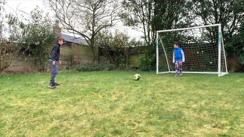 Two boys playing football