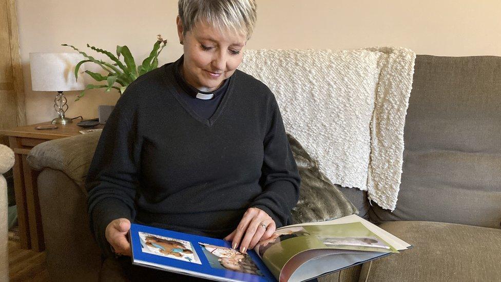 Sharon looking at a book of memories about Leo