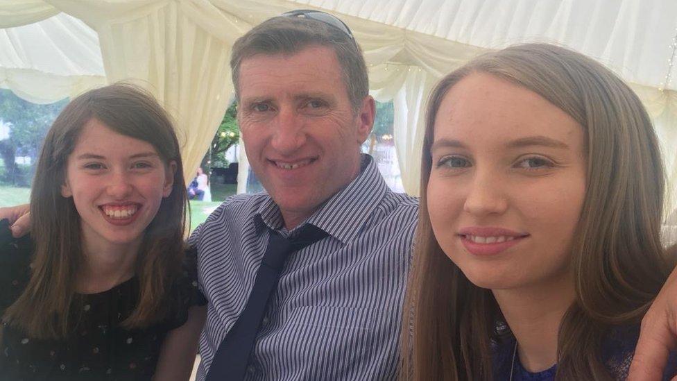 Mali, left, and her twin sister with their father Rhodri. They've run the farm with their mother since his death