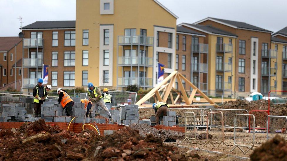 Construction workers building new houses on a housing development