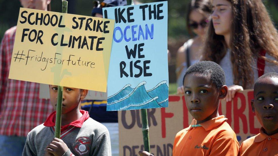 cHILDREN HOLDING PLACARDS