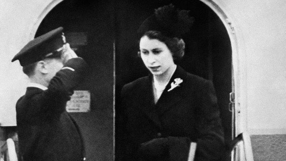 Queen Elizabeth II leaving an aircraft after landing at London Airport at the end of a flight from Kenya following the death of her father, King George VI