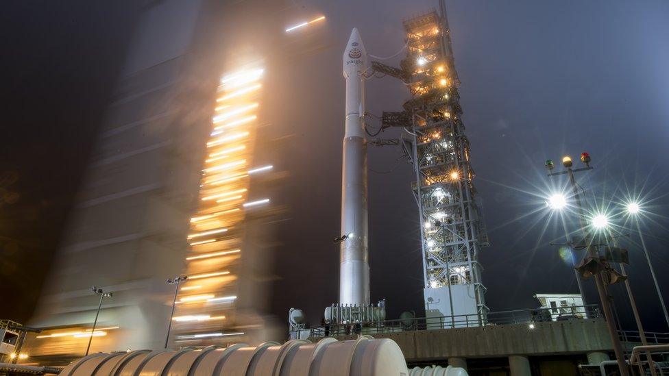 Picture shows InSight on its launch pad in California very early in the morning with lots of lights shining.