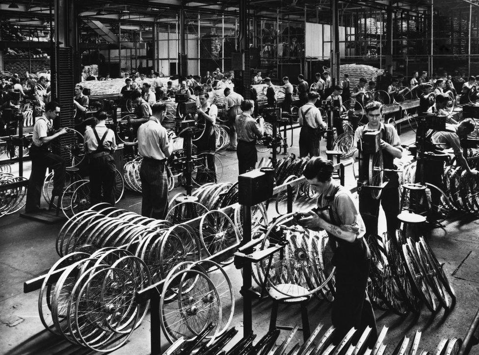 Workers assembling bicycles inside a Raleigh factory in the early 1900s