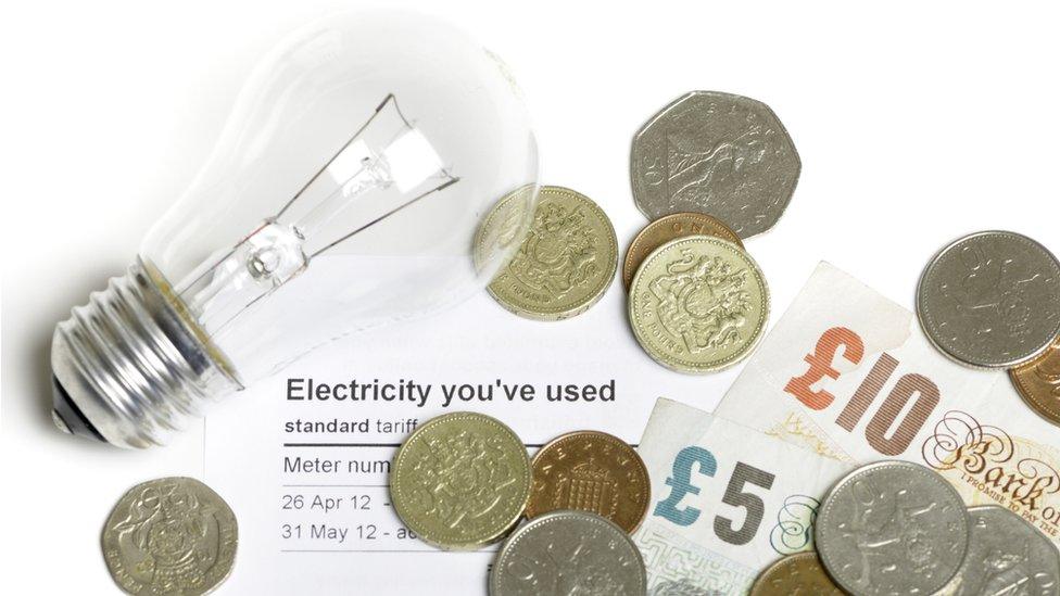 Electricity bill and cash and lightbulb