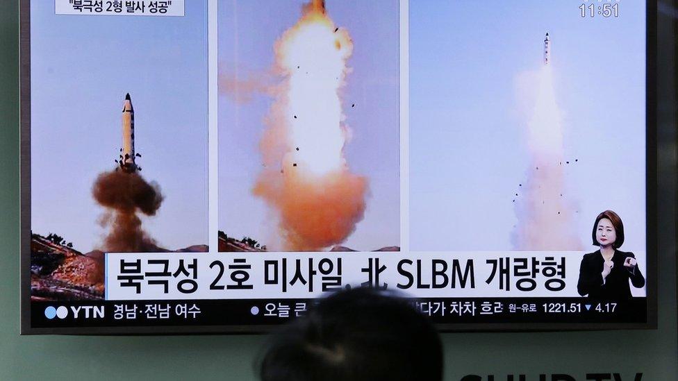 A man watches a TV news program showing photos published in North Korea's Rodong Sinmun newspaper of North Korea's "Pukguksong-2" missile launch at Seoul Railway station in Seoul, South Korea, Monday, 13 February 2017