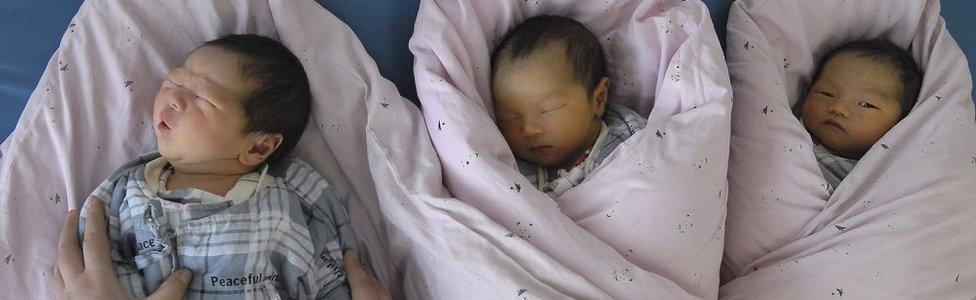 In this 2008 file photo, a nurse takes care of newborn infants at a hospital