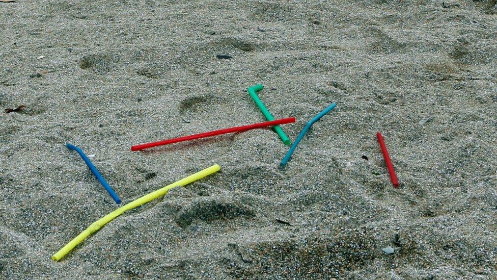 Plastic straws on a beach