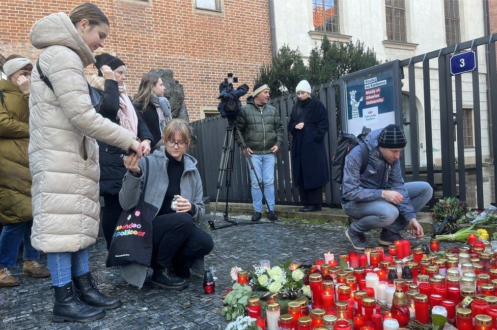 A makeshift shrine to the dead was visited on Friday morning as students tried to make sense of the murders