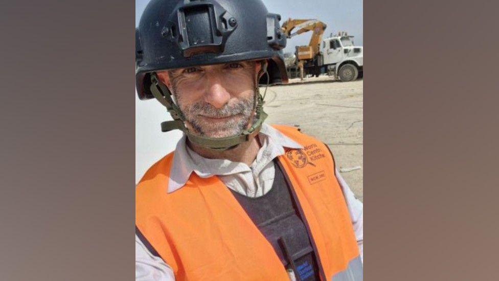 James Kirby in an orange World Central Kitchen jacket and hard hat