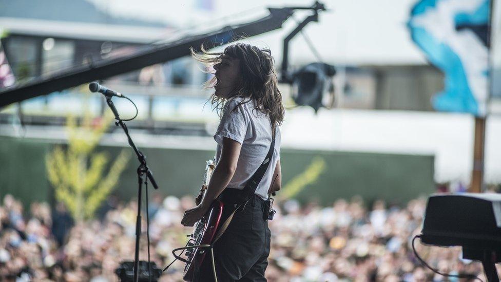 Courtney Barnett playing her guitar