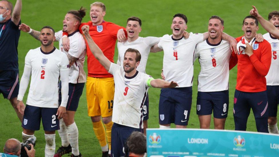 The England squad cheer on the pitch