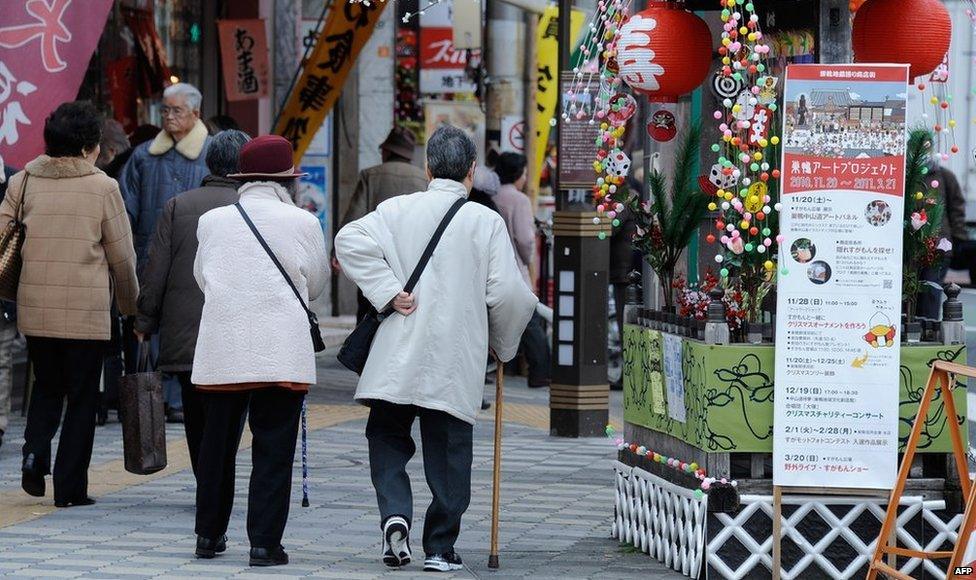 Elderly people walking in a street in Tokyo