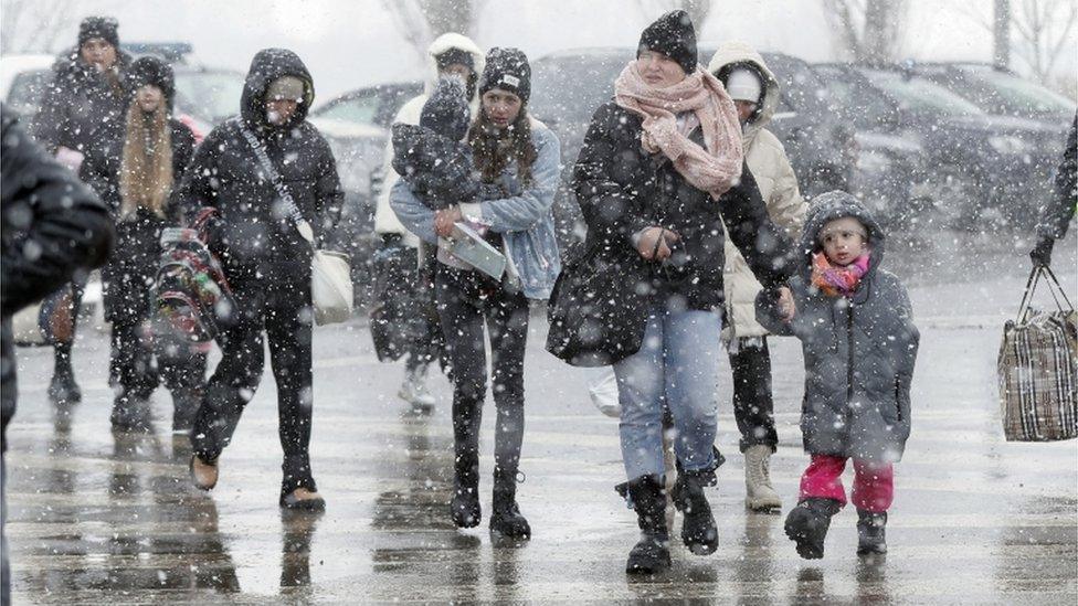 Ukrainian people pass through the border crossing of Siret, northern Romania