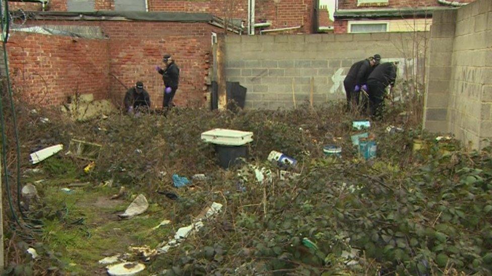 Police officers conduct the search in an area close to the last sighting of Naheed Khan