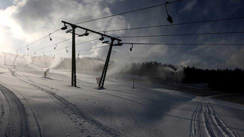 Snow cannons produce artificial snow next to a ski lift on a closed slope in Spital am Semmering, Austria, 2 Dec 20