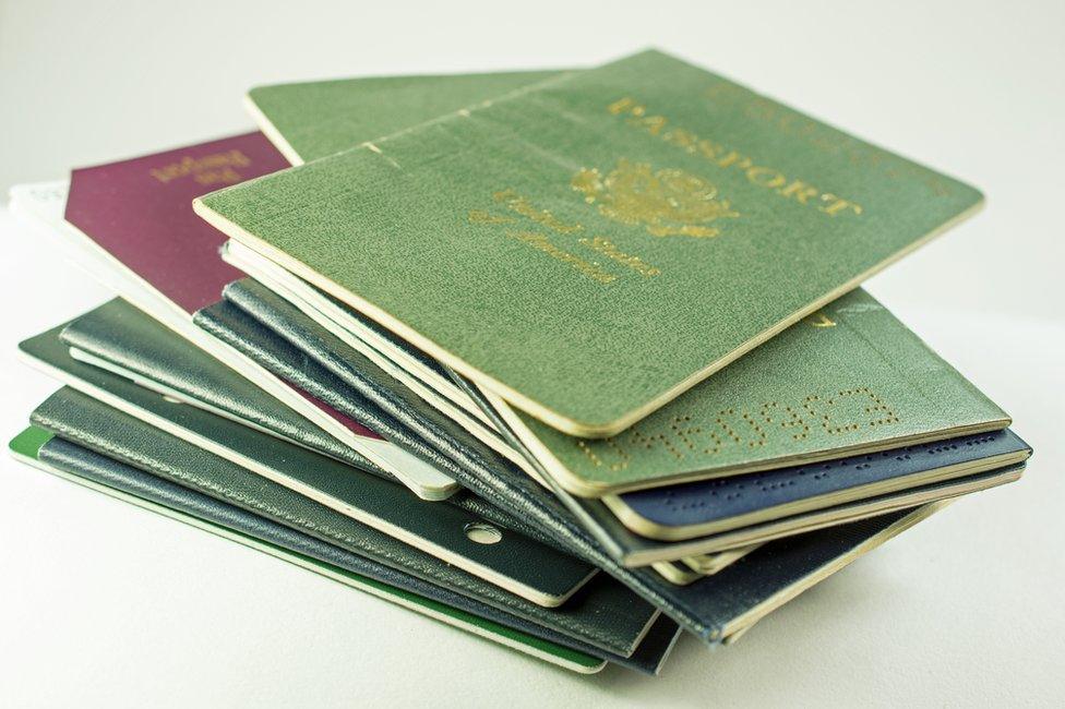 A pile of passports from different countries