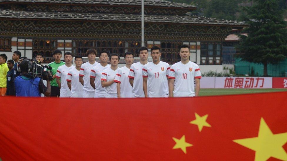 The Chinese team stand at the Bhutan stadium.