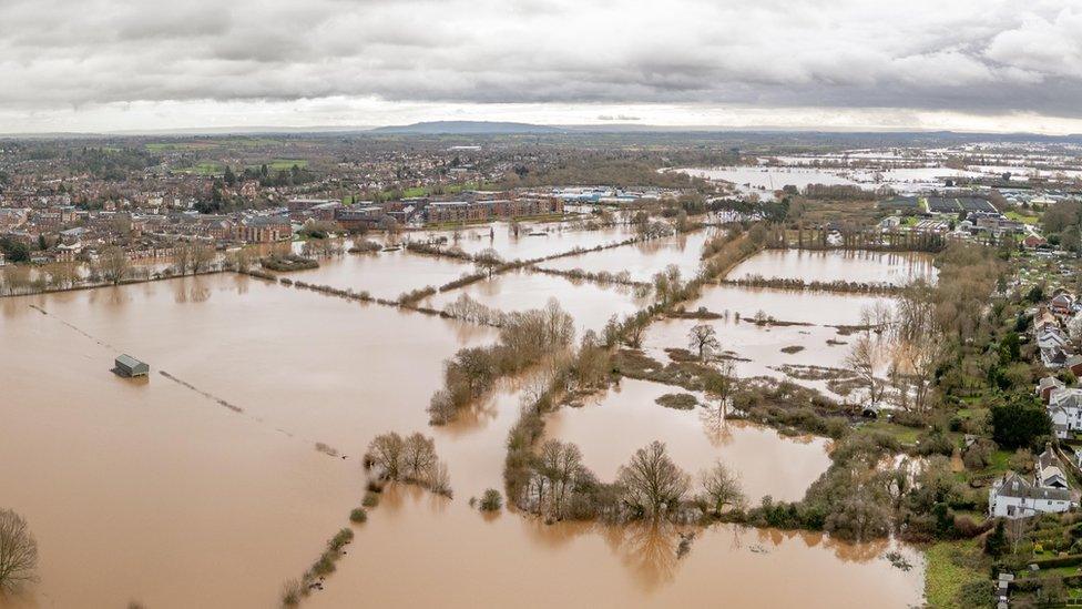 An aerial shot of flooded fields with grey skies overhead