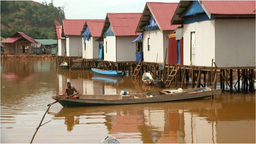 A picture of Boenaga village shows brown water