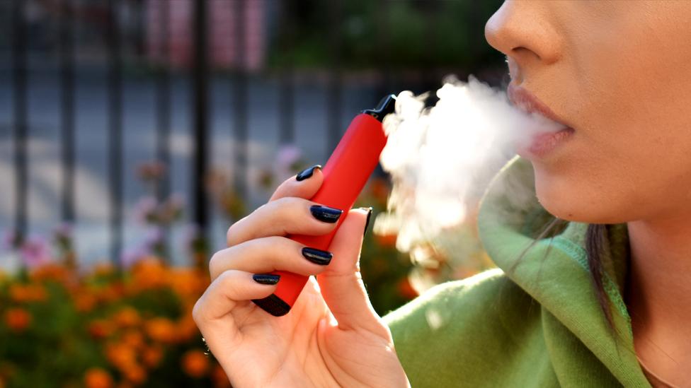 Stock image of a person vaping