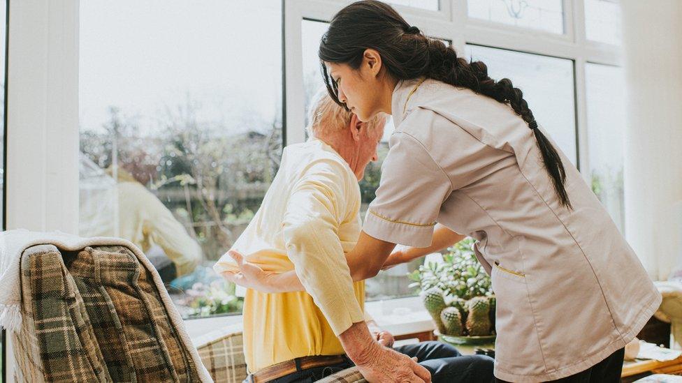 Woman helping elderly person