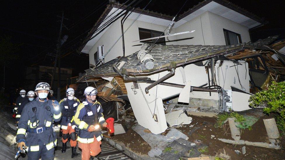 Firefighters check damage to collapsed house in Mashiki, near Kumamoto city. 15 April 2016