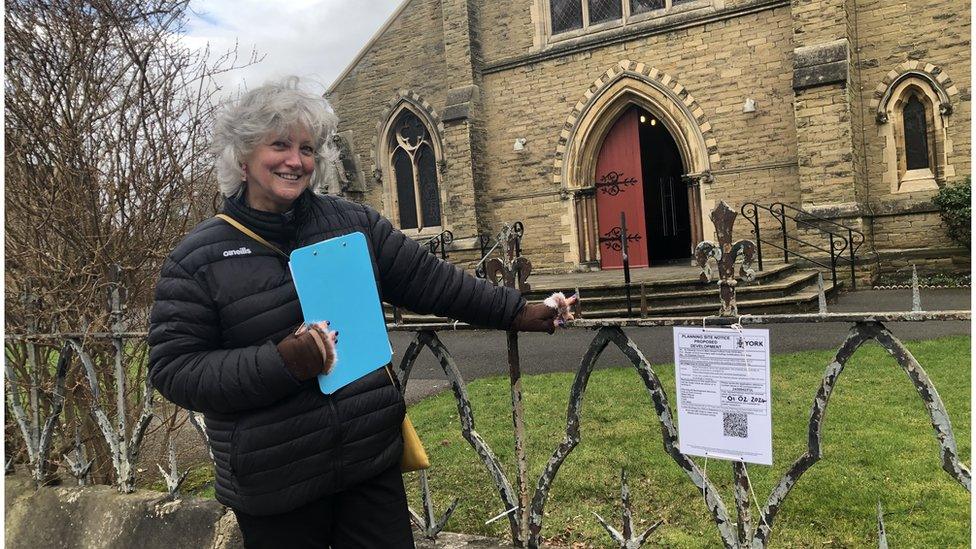 Rev Canon Sue Sheriff standing in front of spikey railings