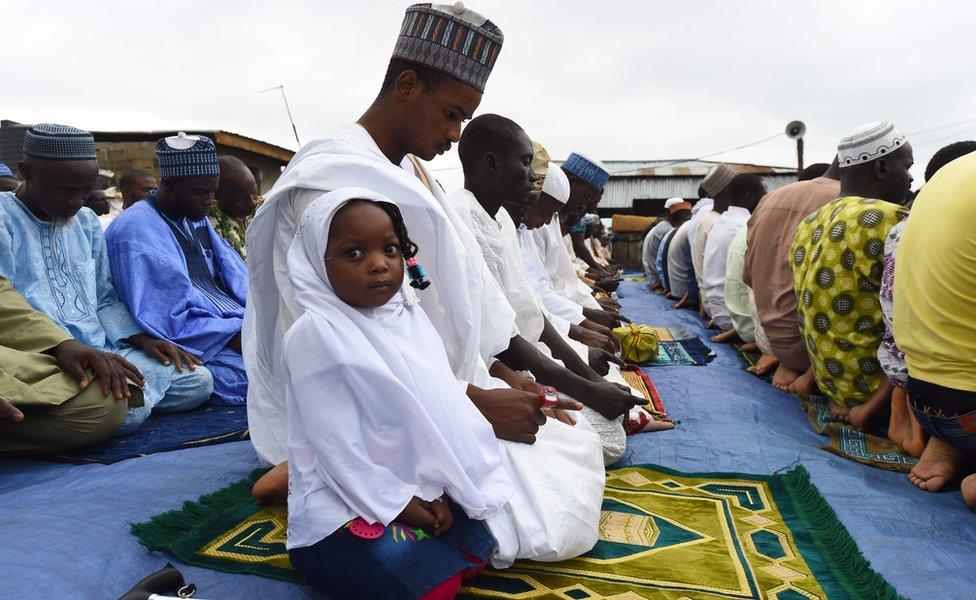 A girl and her father at Eid prayers in Ibafo, Ogun state, Nigeria - Tuesday 21 August 2018