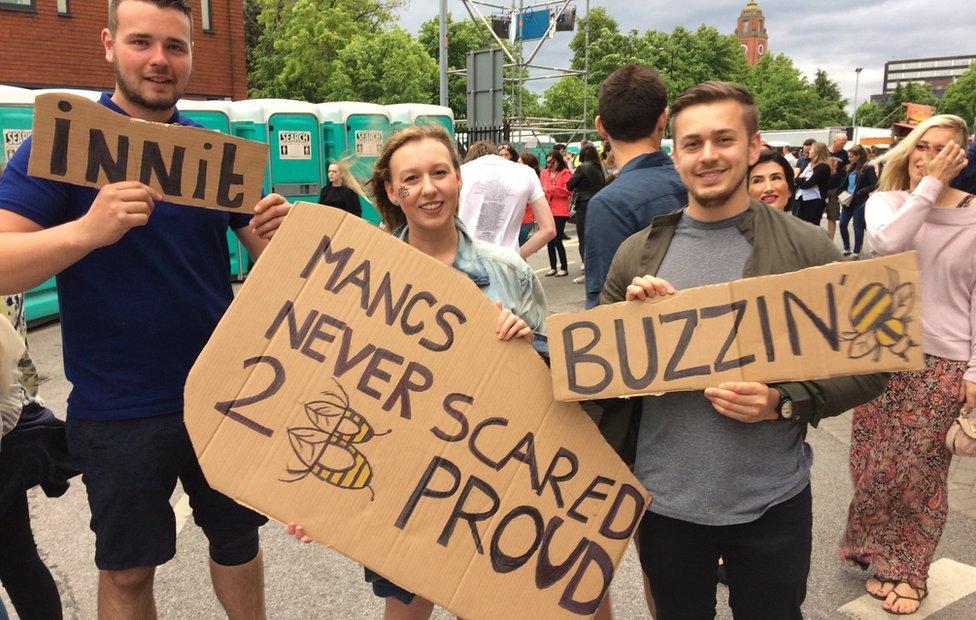 Fans holding signs including "Mancs never scared 2 B proud"