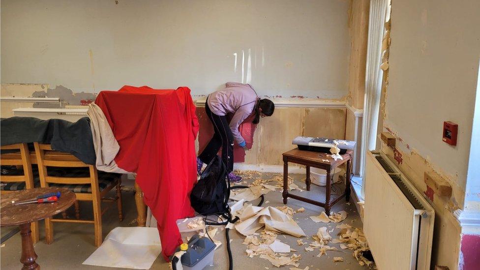 A person redecorates a room