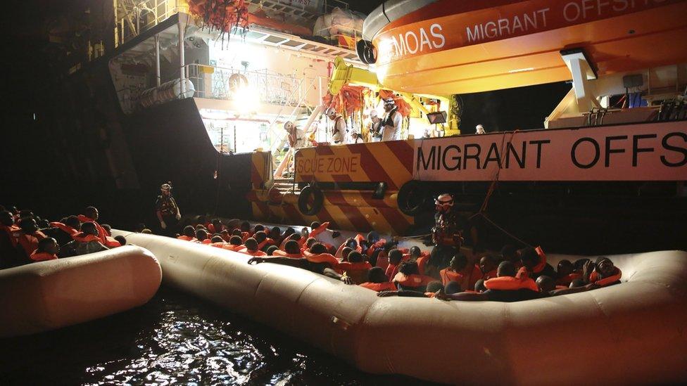 Migrants on dinghy boats are being rescued by the vessel Responder, run by the Malta-based NGO Migrant Offshore Aid Station (MOAS) and the Italian Red Cross, in the Mediterranean sea, early Saturday, Nov. 5, 2016.