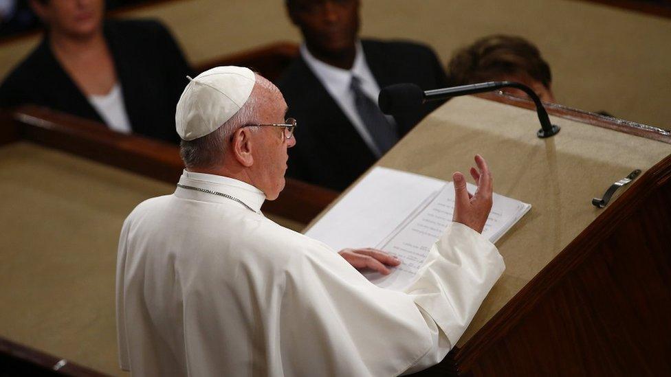 The Pope speaks at the podium