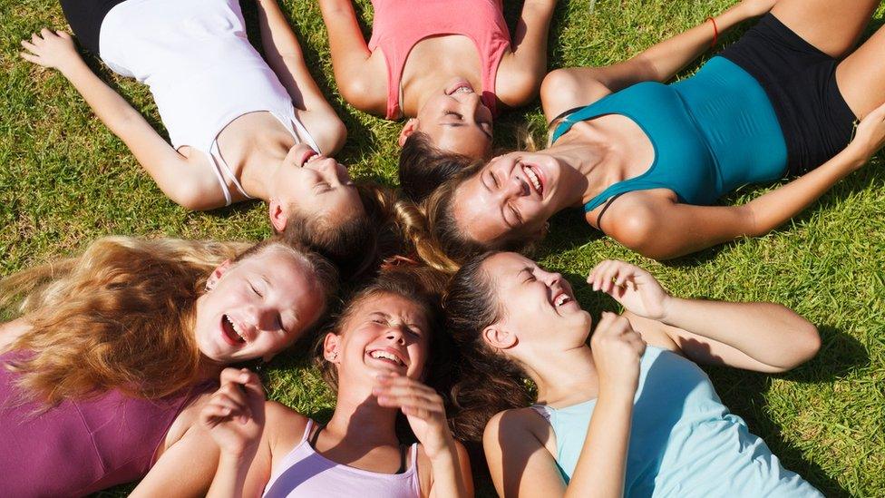 A group of happy girls lying down