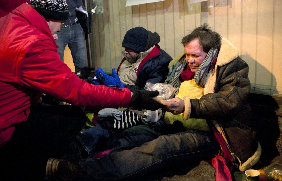 two homeless men during a visit of a team of the Red Cross that searches the streets of Brussels for homeless people, on February 1, 2012.