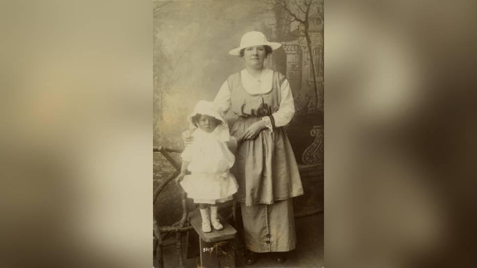 An old photograph of a woman and a young girl