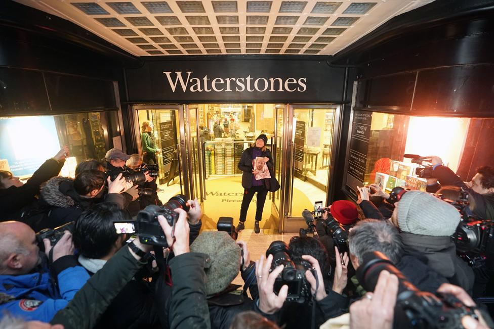 Caroline Lennon, the first customer to purchase a copy of Spare, the newly released autobiography from the Duke of Sussex, poses for photographers with her copy of the book as she leaves Waterstones Piccadilly, London. 10 January 2023.