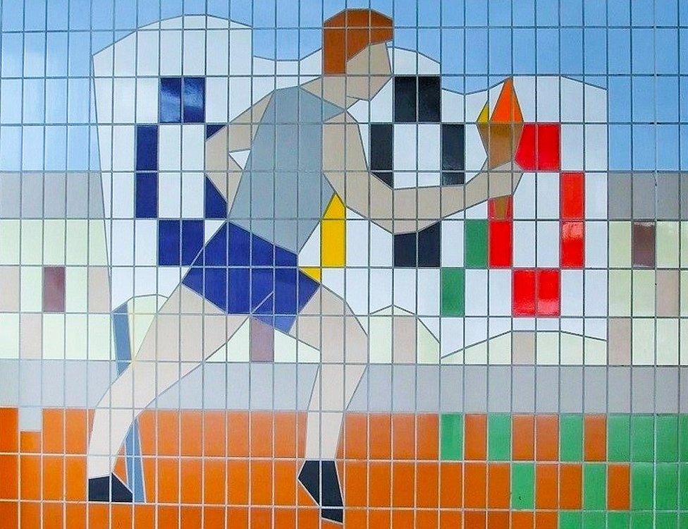 Tile mural of athlete carrying Olympic torch